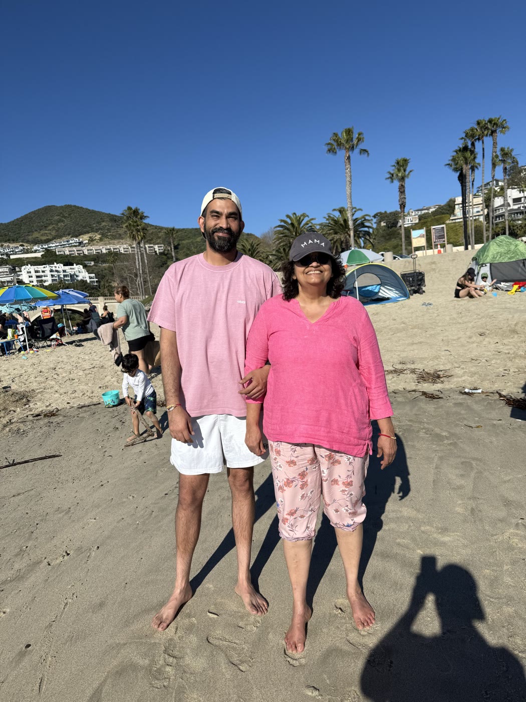 My mom and me standing on a sunny beach